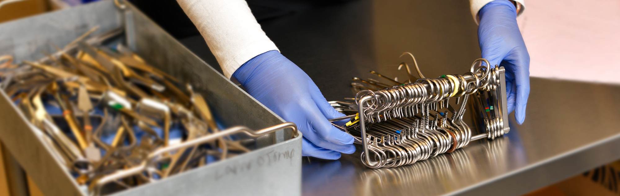 Technician organizes surgical instruments.