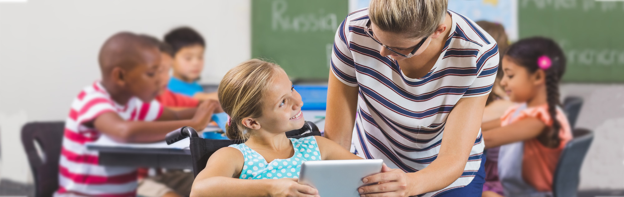 Student teacher assists elementary student.