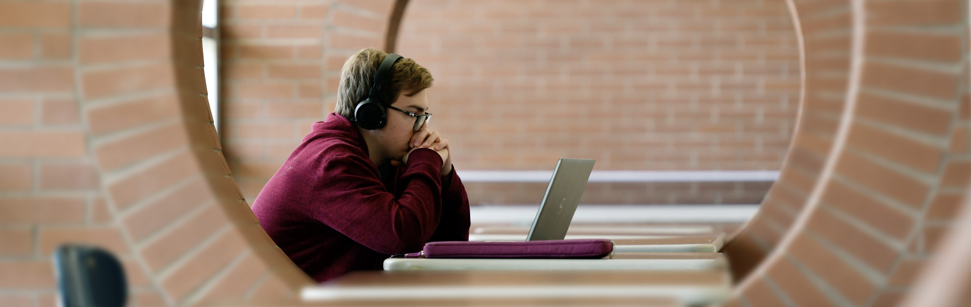 Student studies in a pod in the Student Services building.