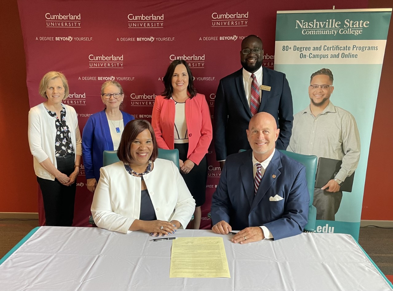 Nashville State President Dr. Shanna L. Jackson and Cumberland University President Dr. Paul C. Stumb sign an articulation agreement on the College's White Bridge campus as Karen Stevenson, dean of Business, Management, and Hospitality; Dr. Carol Martin-Osorio, vice president of Student Affairs and Enrollment Management; Dr. Carol Rothstein, vice president of Academic Affairs and Workforce Development; along with Cumberland's Vice President of Enrollment Services look on.
